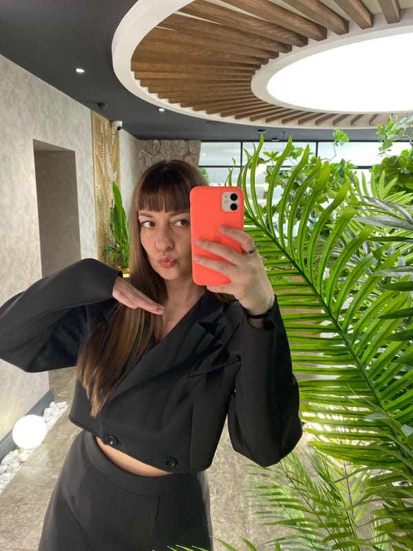 Woman takes selfie with orange phone in Votkinsk