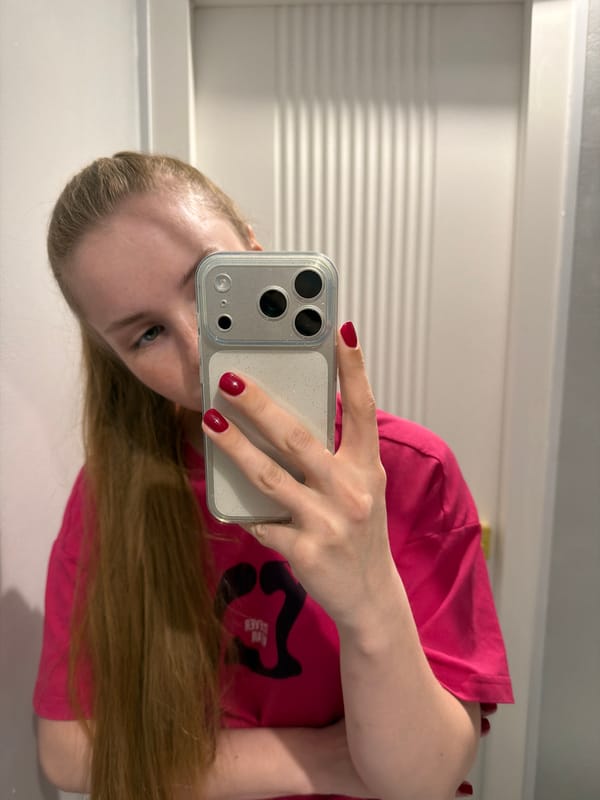Person takes mirror selfies in pink shirt