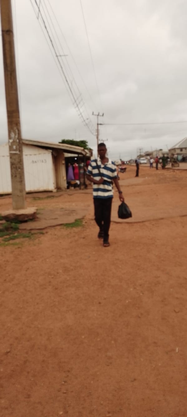 Morning street life along a busy dirt road in Gboko, Nigeria
