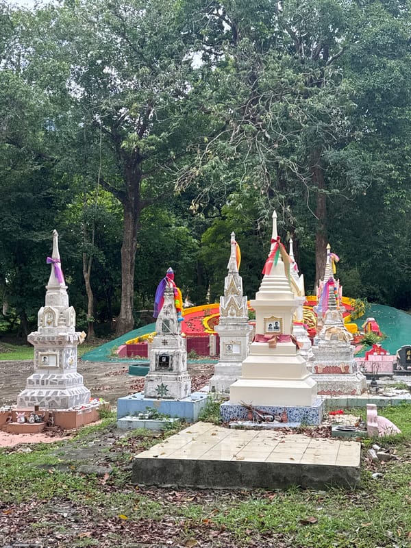Thai community murals and ornate cemetery tombs in Wichit