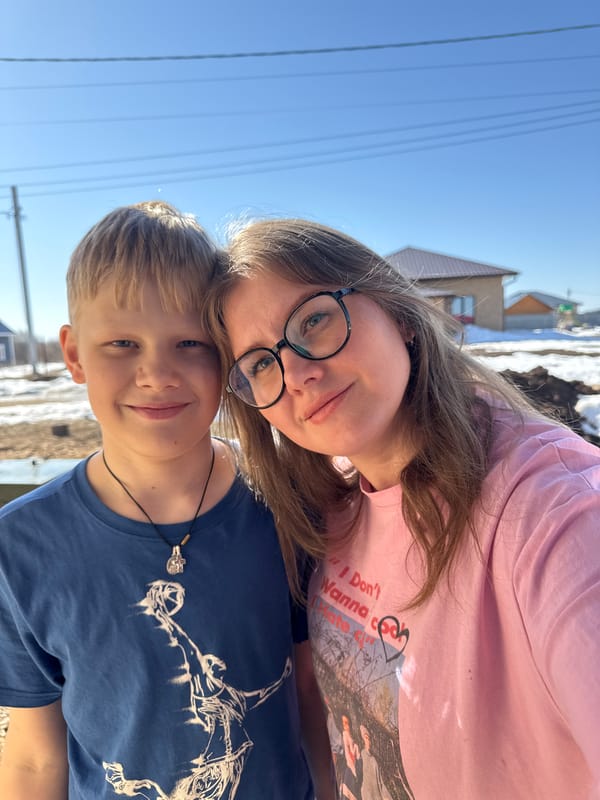 Family morning moments captured at window in Russian village