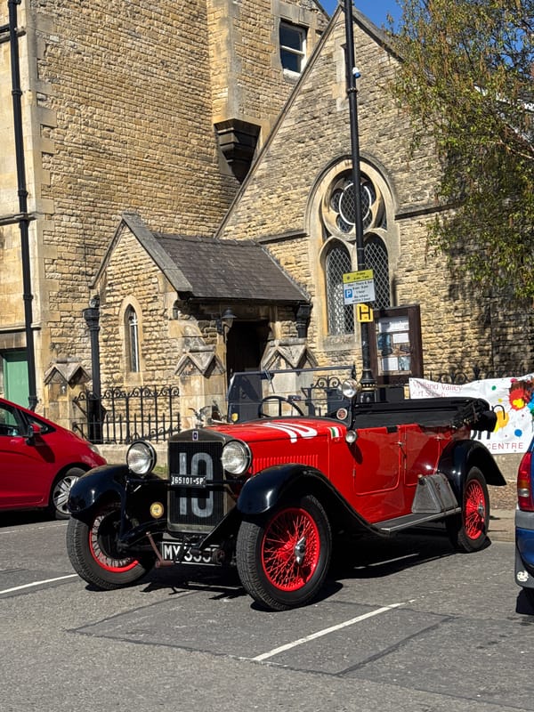 Vintage open-top car spotted near historic building in South Kesteven