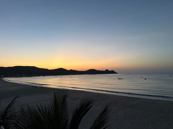 Coastal dawn, sky gradients and silhouetted hills
