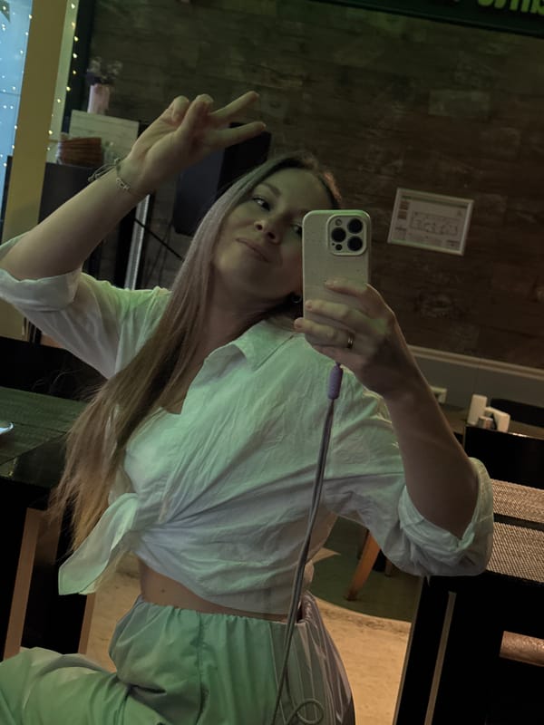 Woman takes selfies around Budva during sunset hour