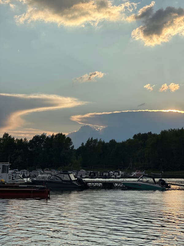Boats moored at a Volga River marina during sunset