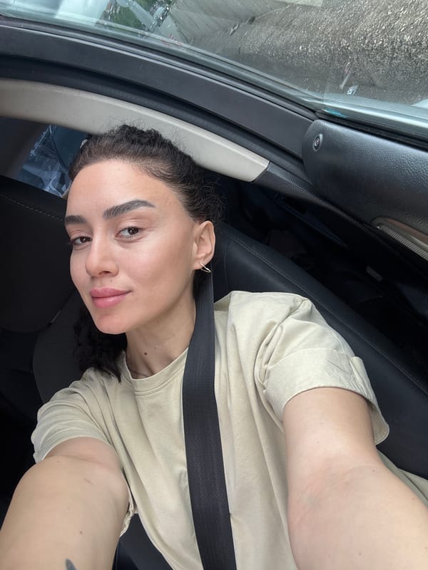 Woman takes selfies in car driver's seat, Tbilisi