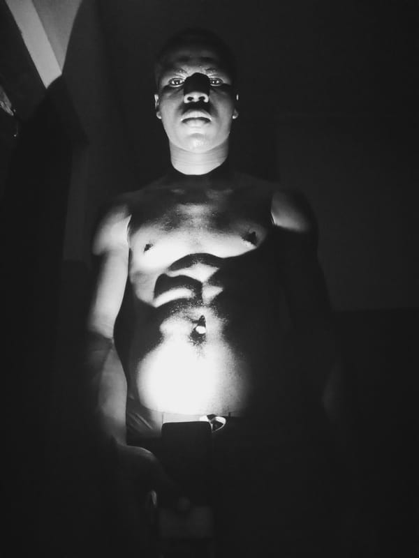 Man photographed in low-light indoor setting in Nkpor, Nigeria