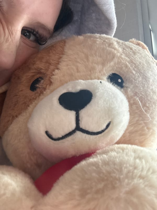 Person photographed in close-up with teddy bear