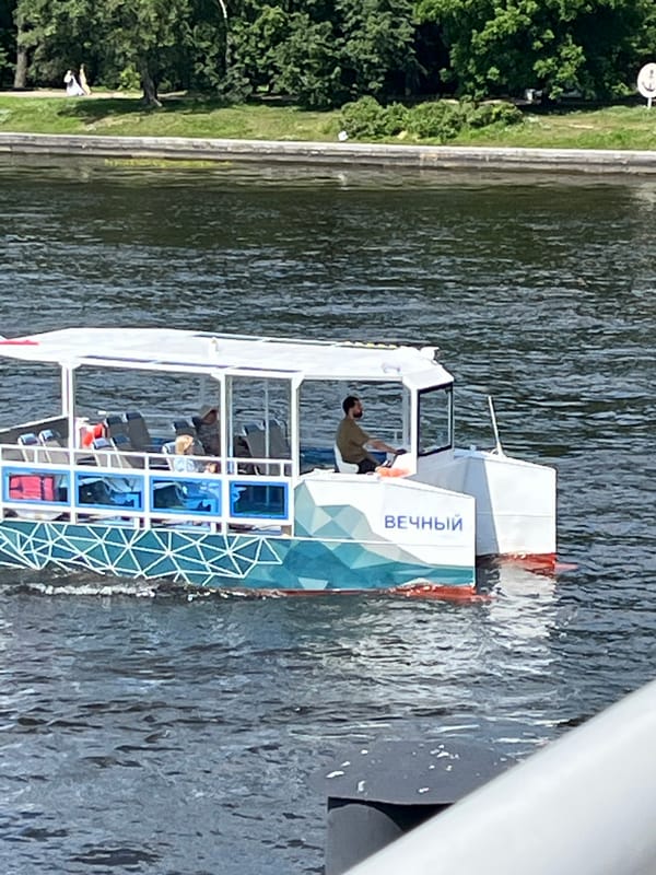 Sunny morning on the Neva River, passenger boats in motion