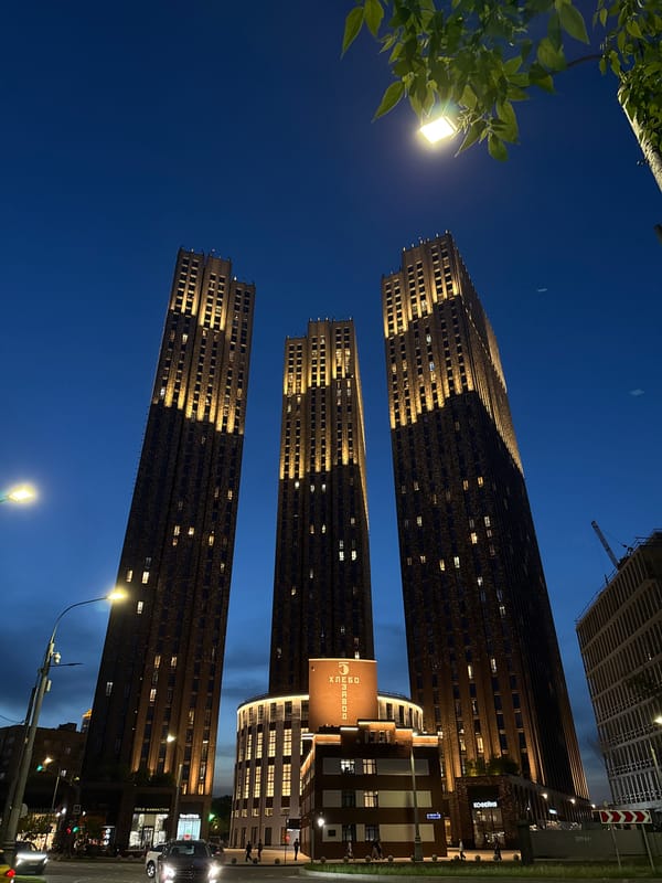 Moscow skyscrapers illuminated at night, captured by witness