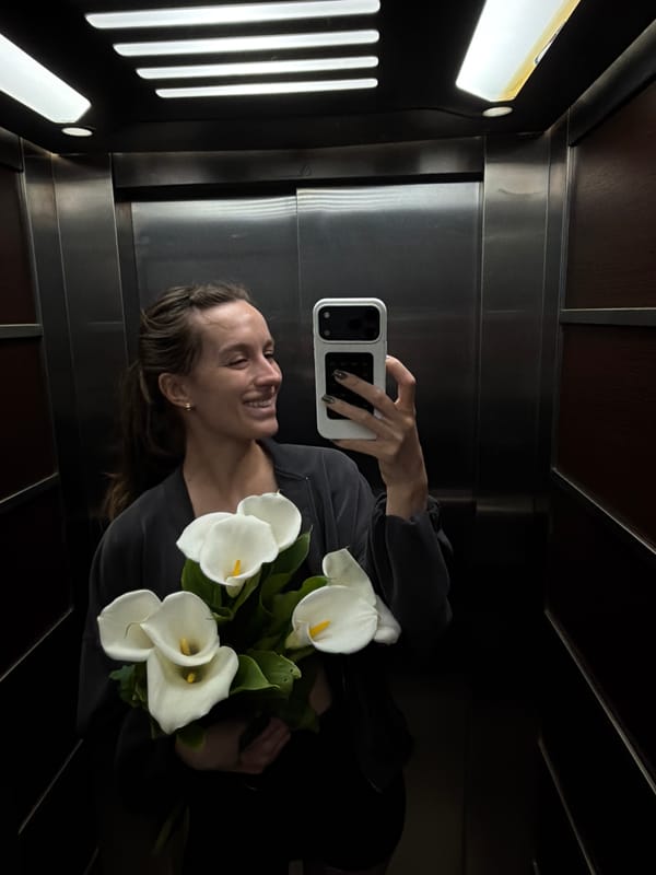 Woman takes elevator selfie with flowers in Budva