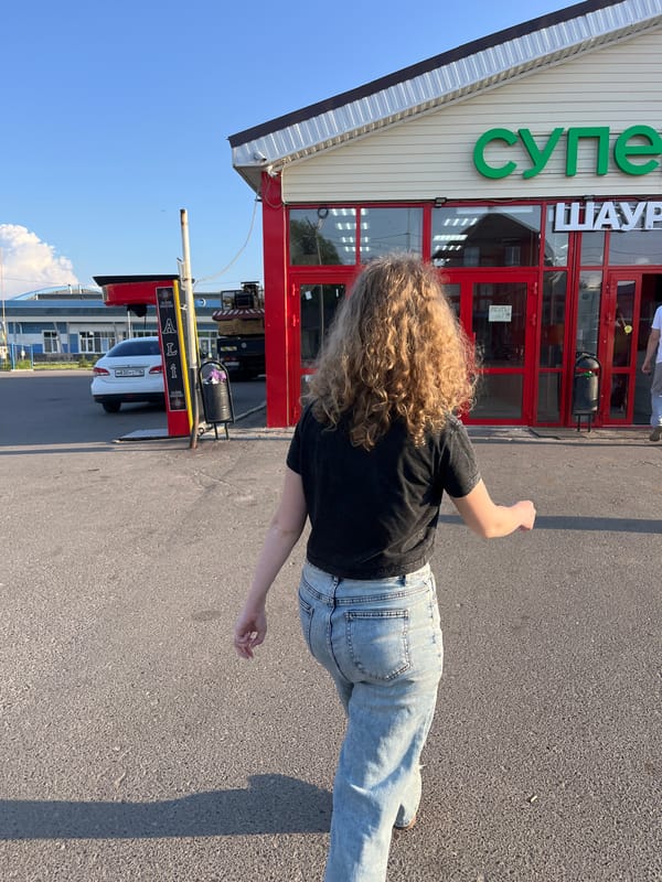 Walking toward red building in Vasilyevo, Russia