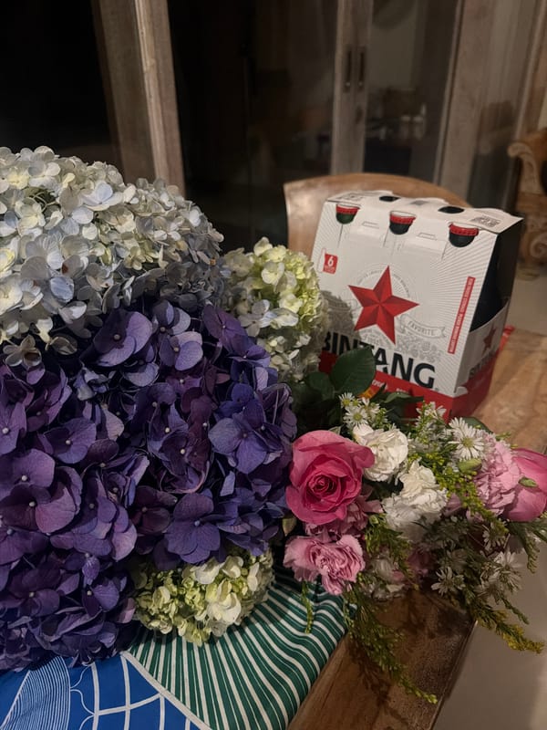 Bintang beer carton photographed with flowers in Ubud