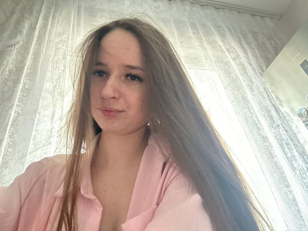 Woman in pink shirt photographed from low angle