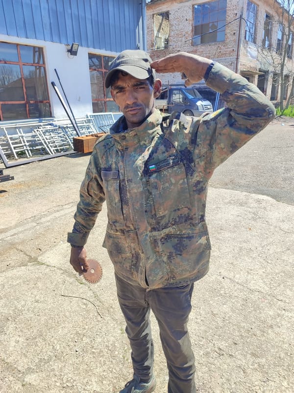 Bulgarian soldier salutes while holding saw blade in Burgas