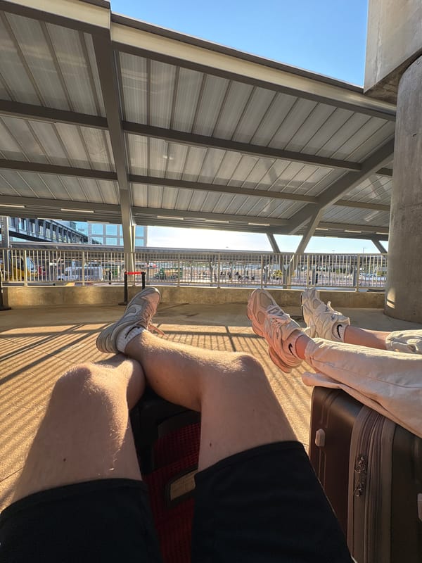 Two people sit together at College Park transit platform