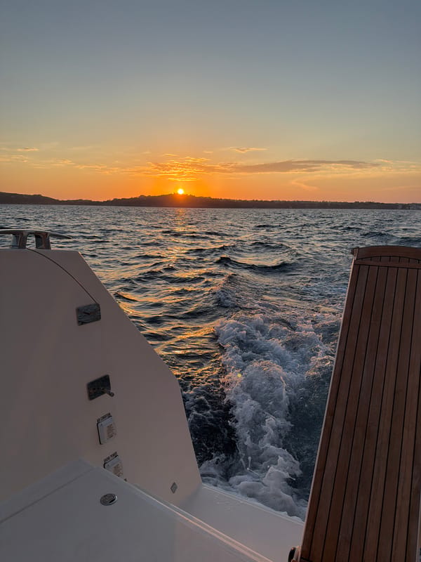 Evening boat departure captured near Procida coastline at sunset