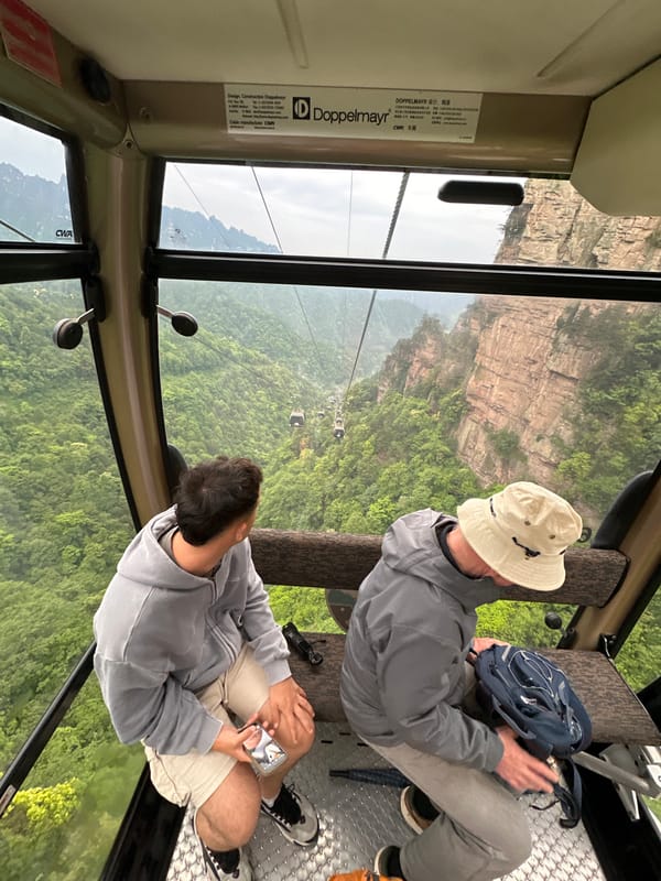 Cable car riders view Wulingyuan's sandstone pillars in China