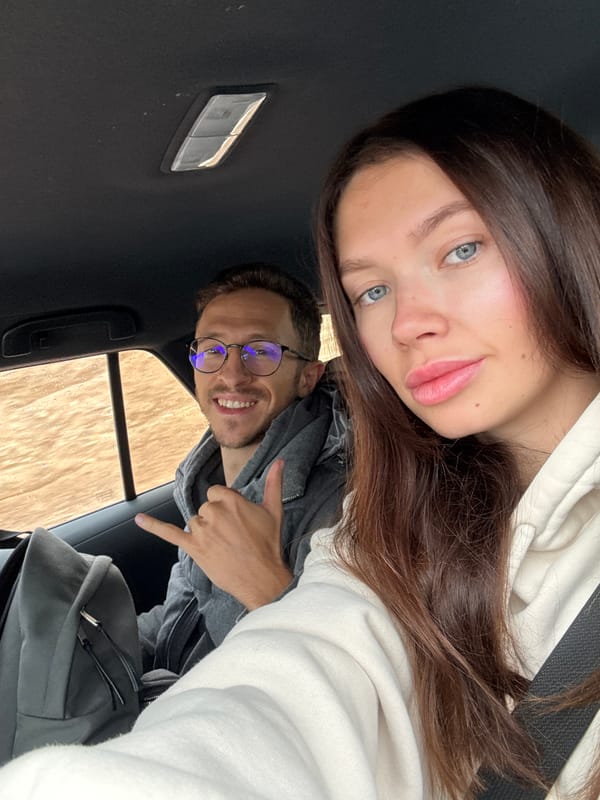 Travelers take selfie while driving through Eilat Mountains desert