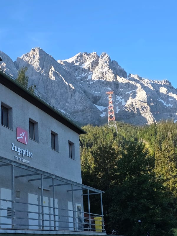 Building photographed against mountain backdrop at dawn