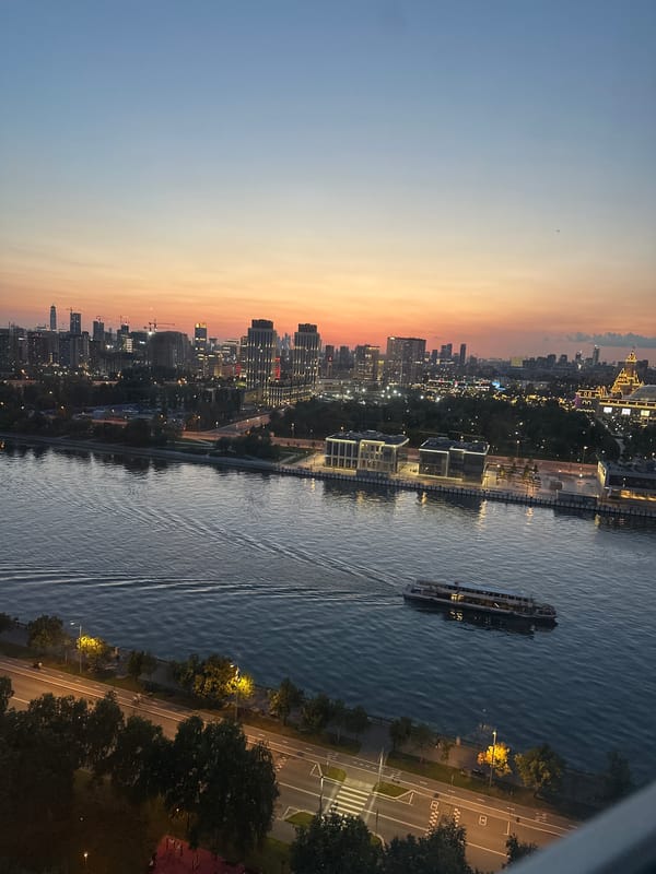 Moscow skyline glows at dusk over the river
