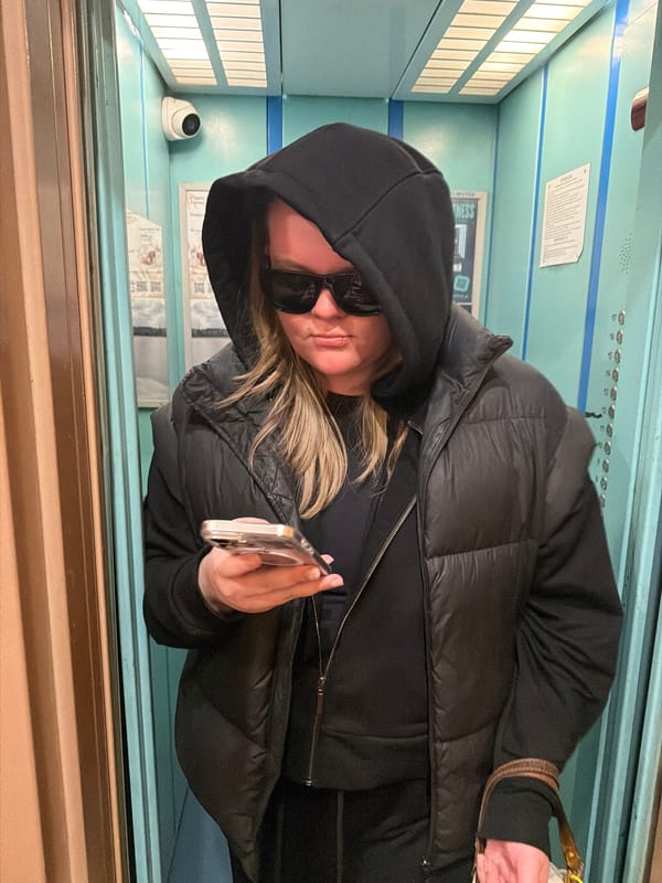 Woman with phone rides elevator in Saint Petersburg