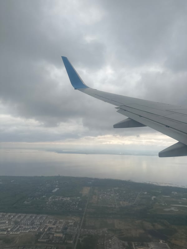 Passenger documents aerial view of coastal Russian city from airplane