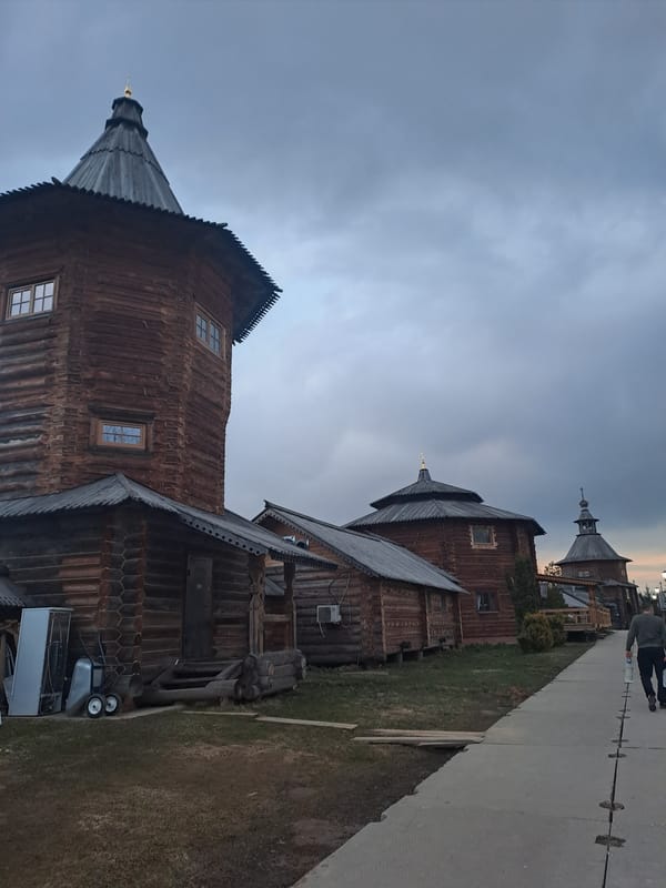 Family visits historic wooden church complex in Vzglyadnevo, Russia