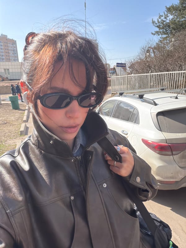 Woman takes outdoor selfie in bright Moscow sunlight