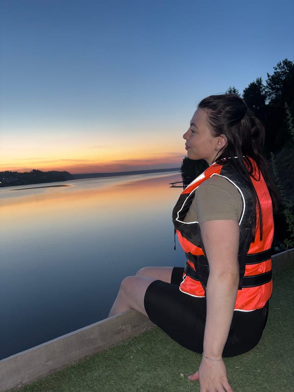 Woman in life jacket spotted at Russian lakeside during sunset