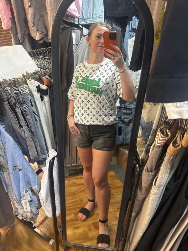 Mirror selfies at a Dnipro clothing store, July 2026