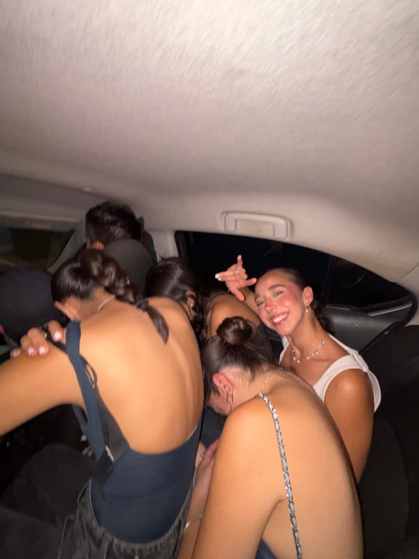 Young people gather together inside vehicle in friendly moment