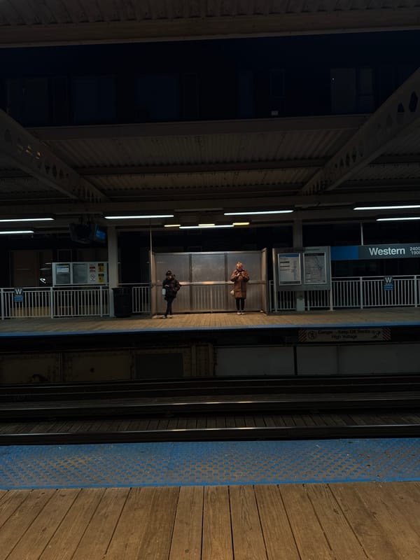 Late night commuters wait at Chicago Western CTA station