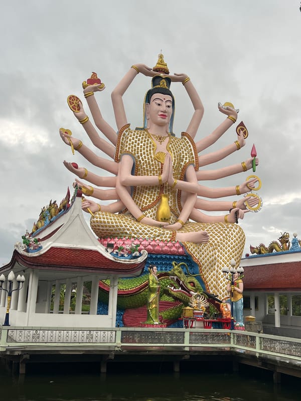 Tourist visits Wat Plai Laem temple complex in Thailand