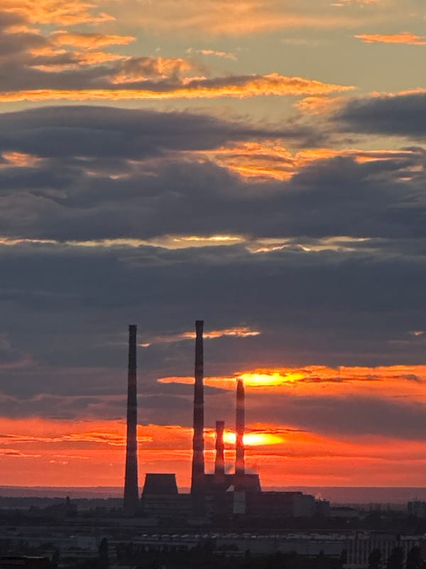 Golden hour over an industrial city skyline