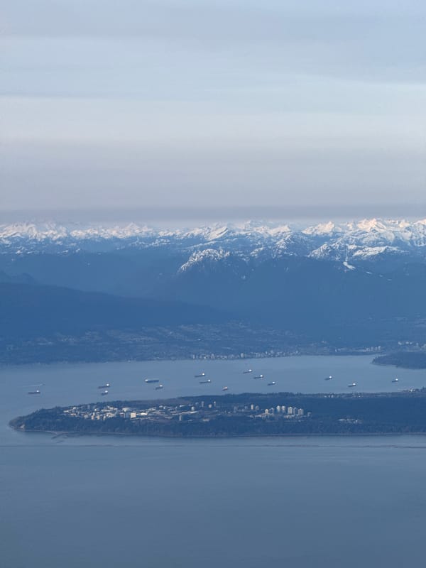Aerial view captures Strait of Georgia with snow-capped mountains