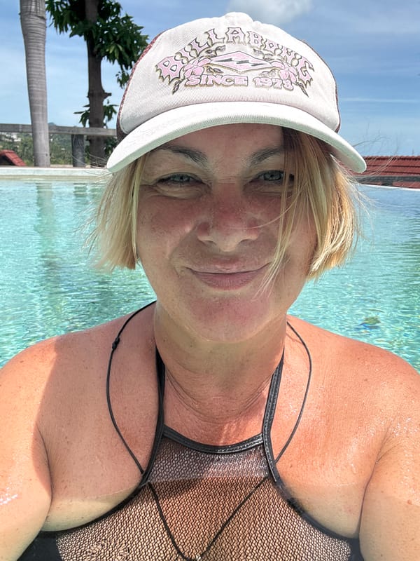 Woman enjoys early morning swim at Thai resort pool