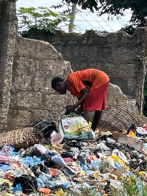 Searching through a debris pile in Ihiagwa, Nigeria