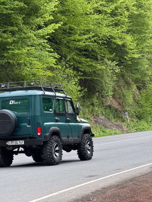 Ordinary moments captured in Dilijan: parked jeep, man eating corn