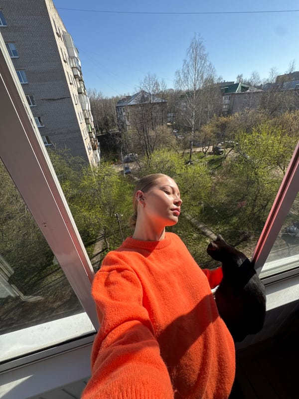 Woman and black cat share morning moments in Chaikovsky