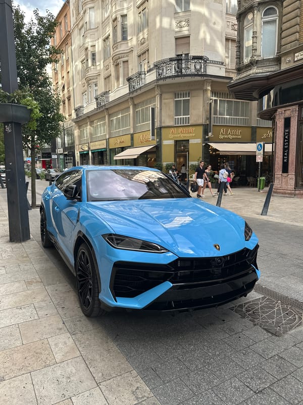 Bright blue Lamborghini Urus parked on a Budapest street
