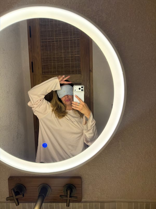 Person photographed in bathroom wearing sleep mask in Mengwi