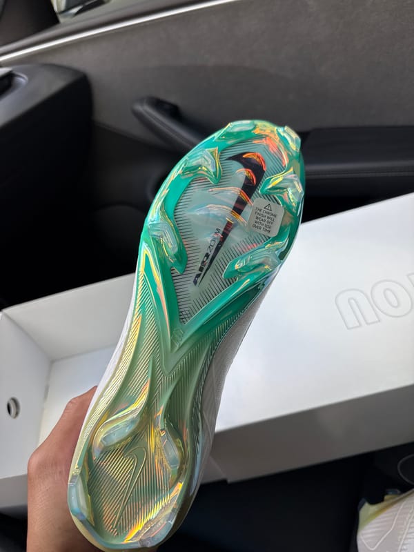 Person showcases new soccer cleats inside Los Angeles vehicle