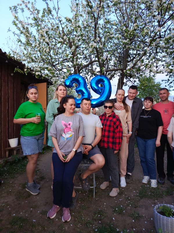 Ten people gather in backyard, location unknown