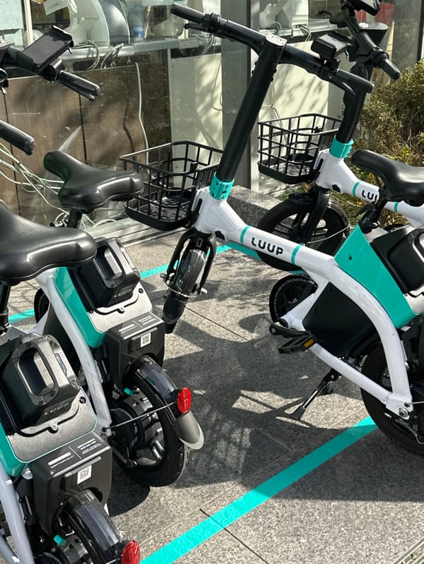 E-bikes parked near no-parking sign in Osaka