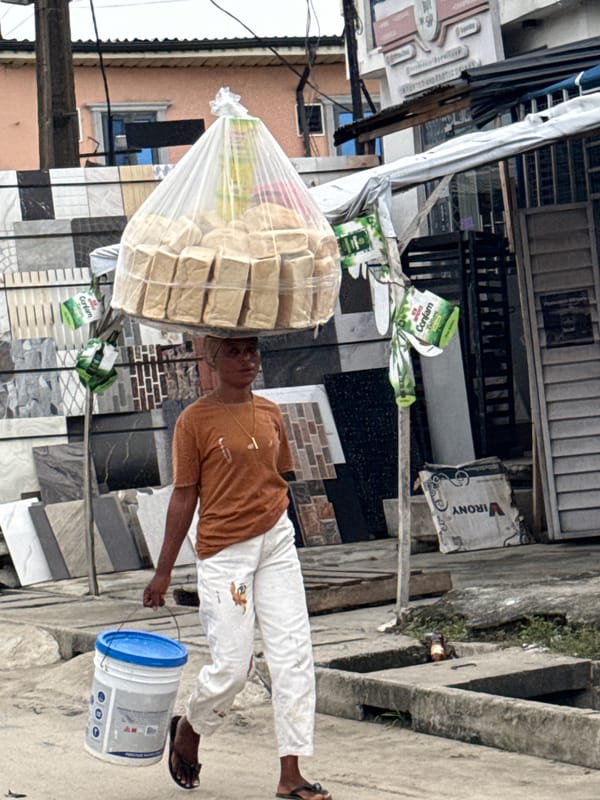 Daily life documented on Ado streets amid auto-rickshaw activity