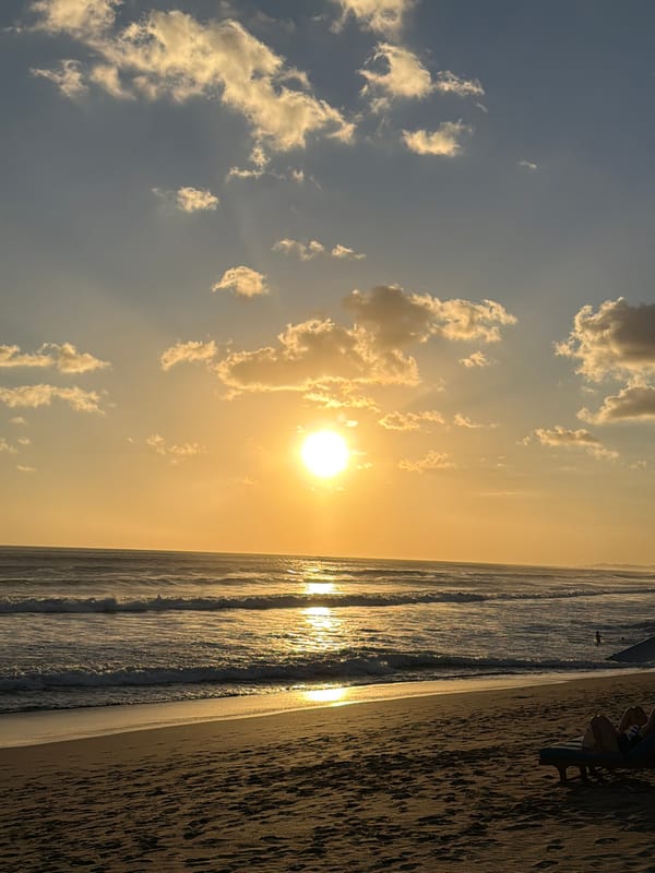 Busy Bali beach sunset, North Kuta shoreline alive with activity