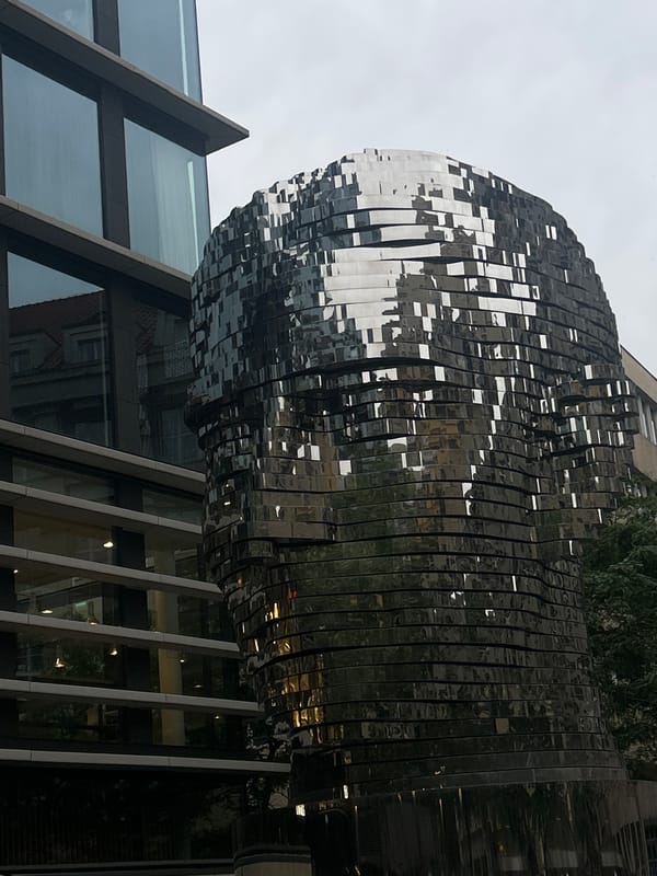 Prague evening walk captures Kafka sculpture, shopping areas