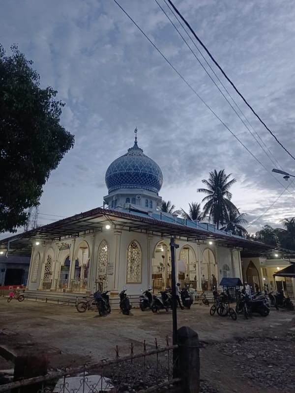Evening gathering and cooking near a village mosque in Aceh