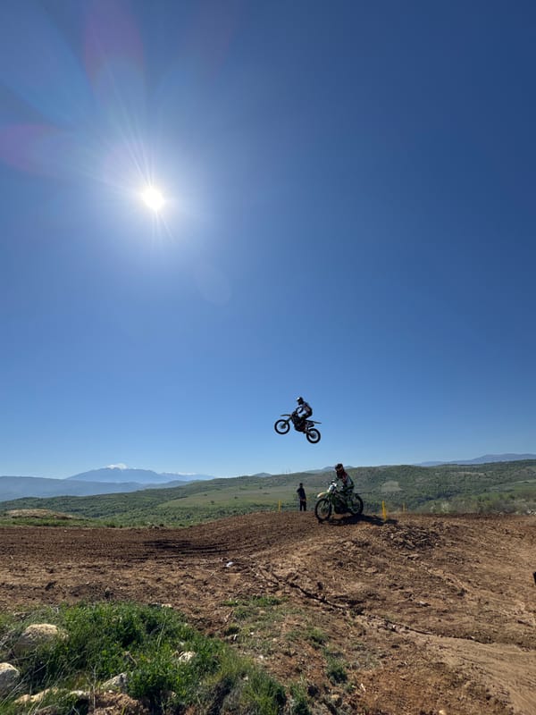 Motocross riders perform jumps at Bulgarian dirt track